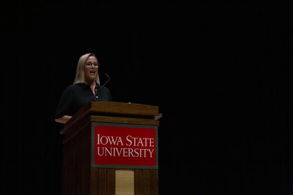 S.E. Cupp standing at a podium