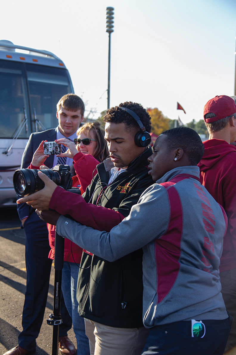 Les Mwirichia and Kobe Gaines look at a camera at an Iowa State tailgate.